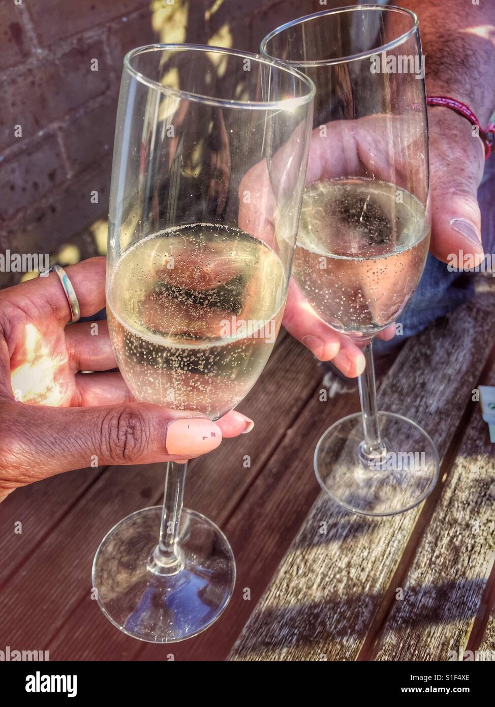Toasting two glasses of champagne - Smartphone Captured Stock Image