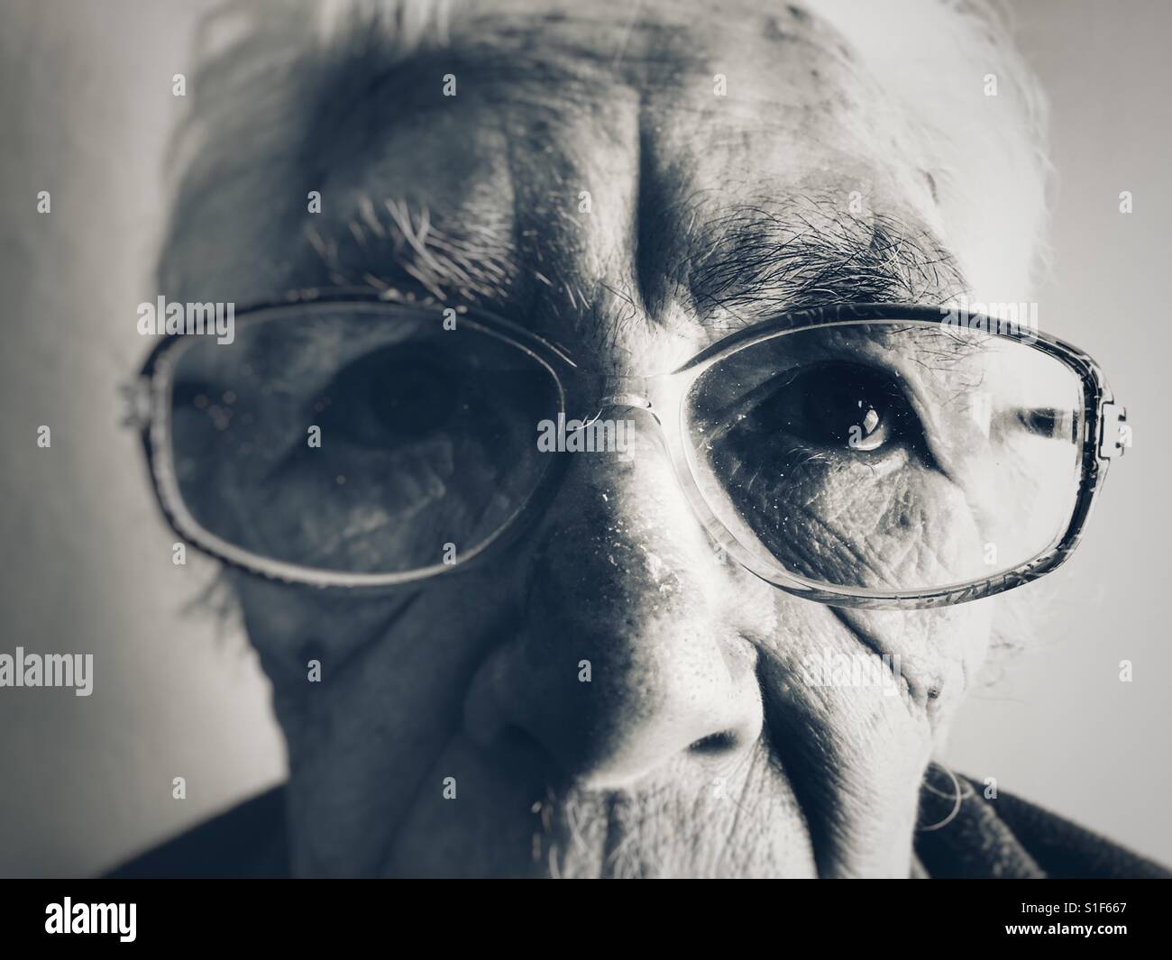 Elderly woman suffering from macular degeneration in her eyes - Smartphone Captured Stock Image