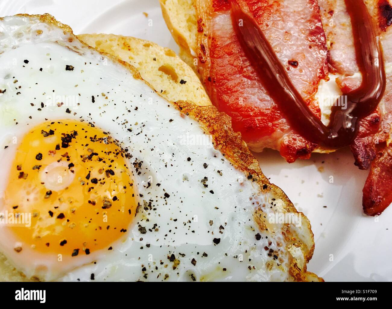 Fried egg and bacon roll with brown sauce - Smartphone Captured Stock Image