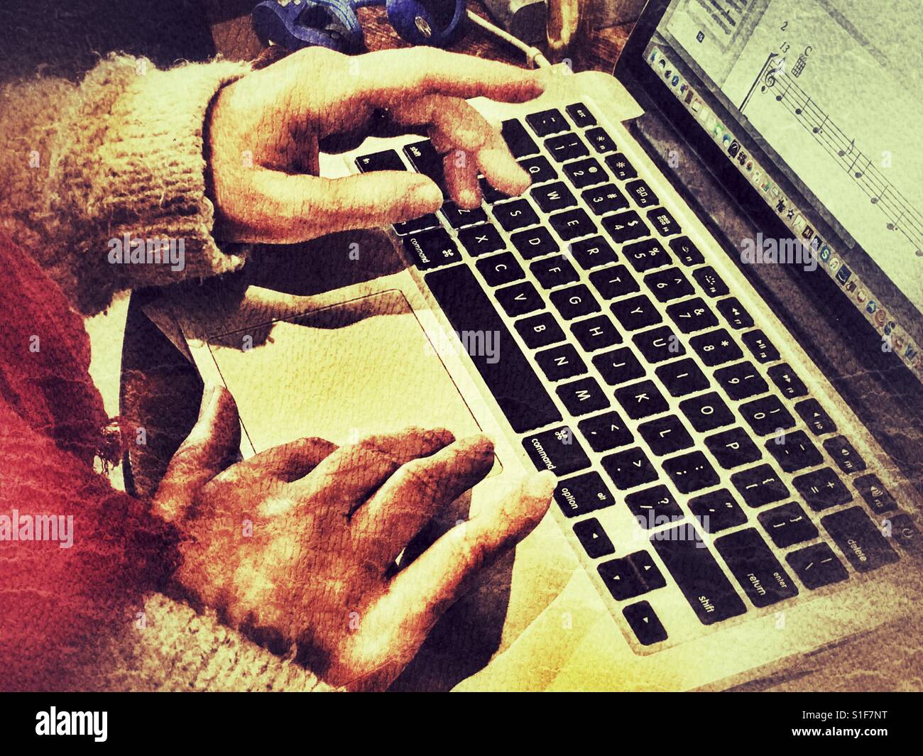Hands on laptop keyboard and trackpad, close up - Smartphone Captured Stock Image