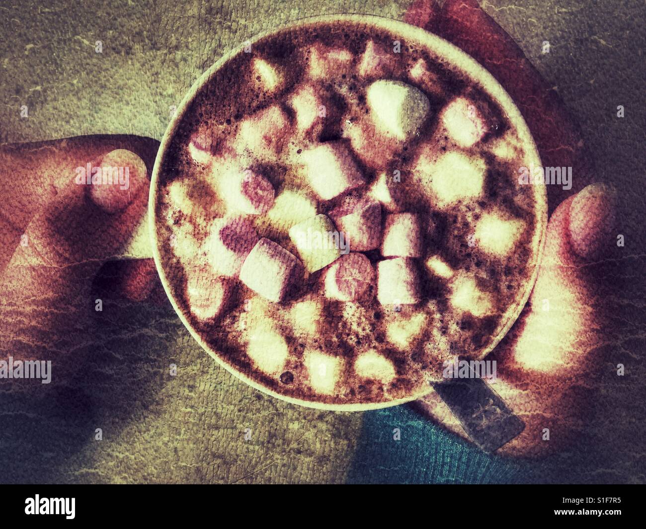 Mug of hot chocolate with marshmallows in teenager' hands - Smartphone Captured Stock Image