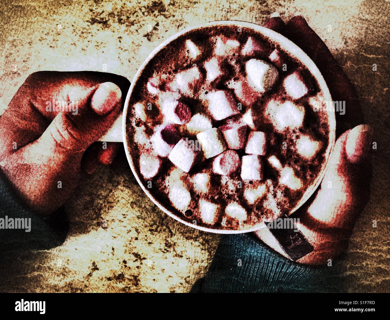 Mug of hot chocolate with mini marshmallows in teenager's hands - Smartphone Captured Stock Image