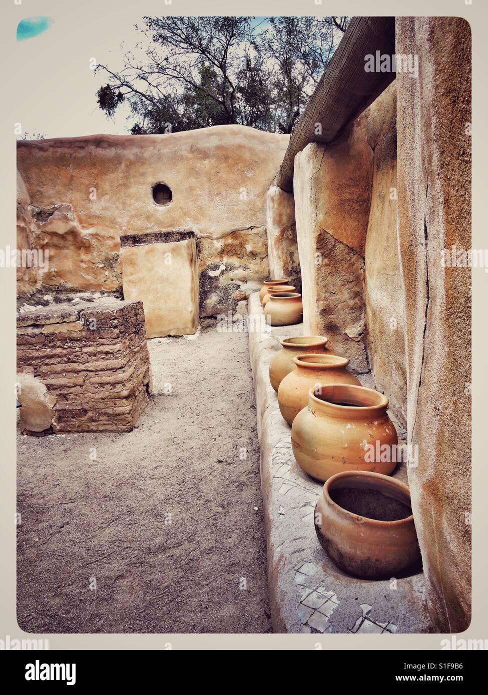 Adobe walls and Indian pottery Stock Photo