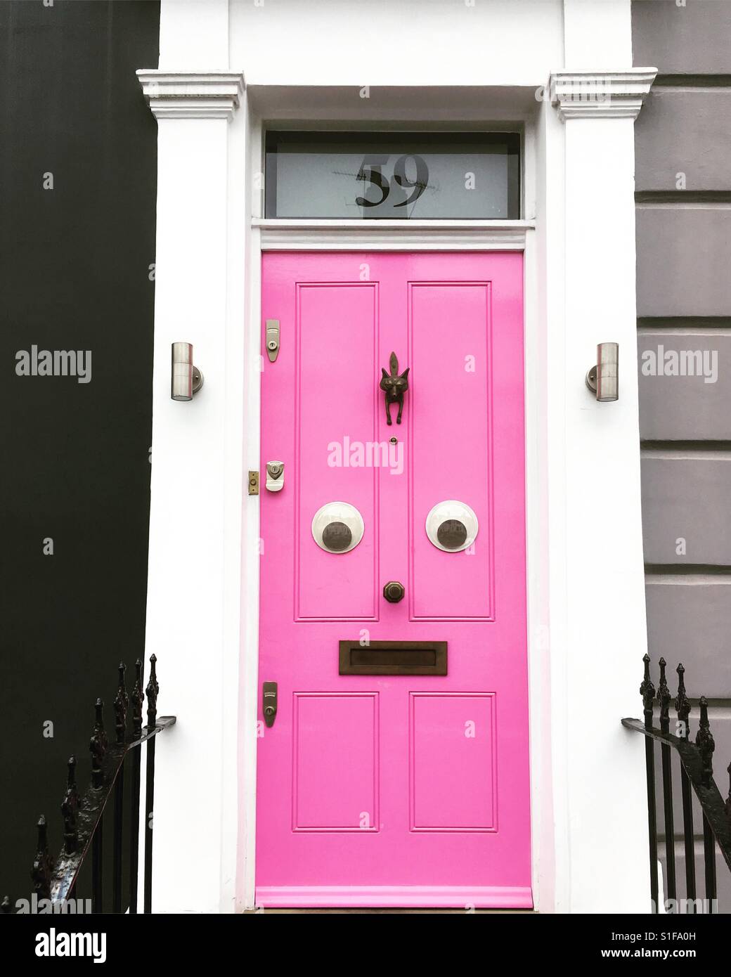 Pink door with eyes - funny face Stock Photo - Alamy