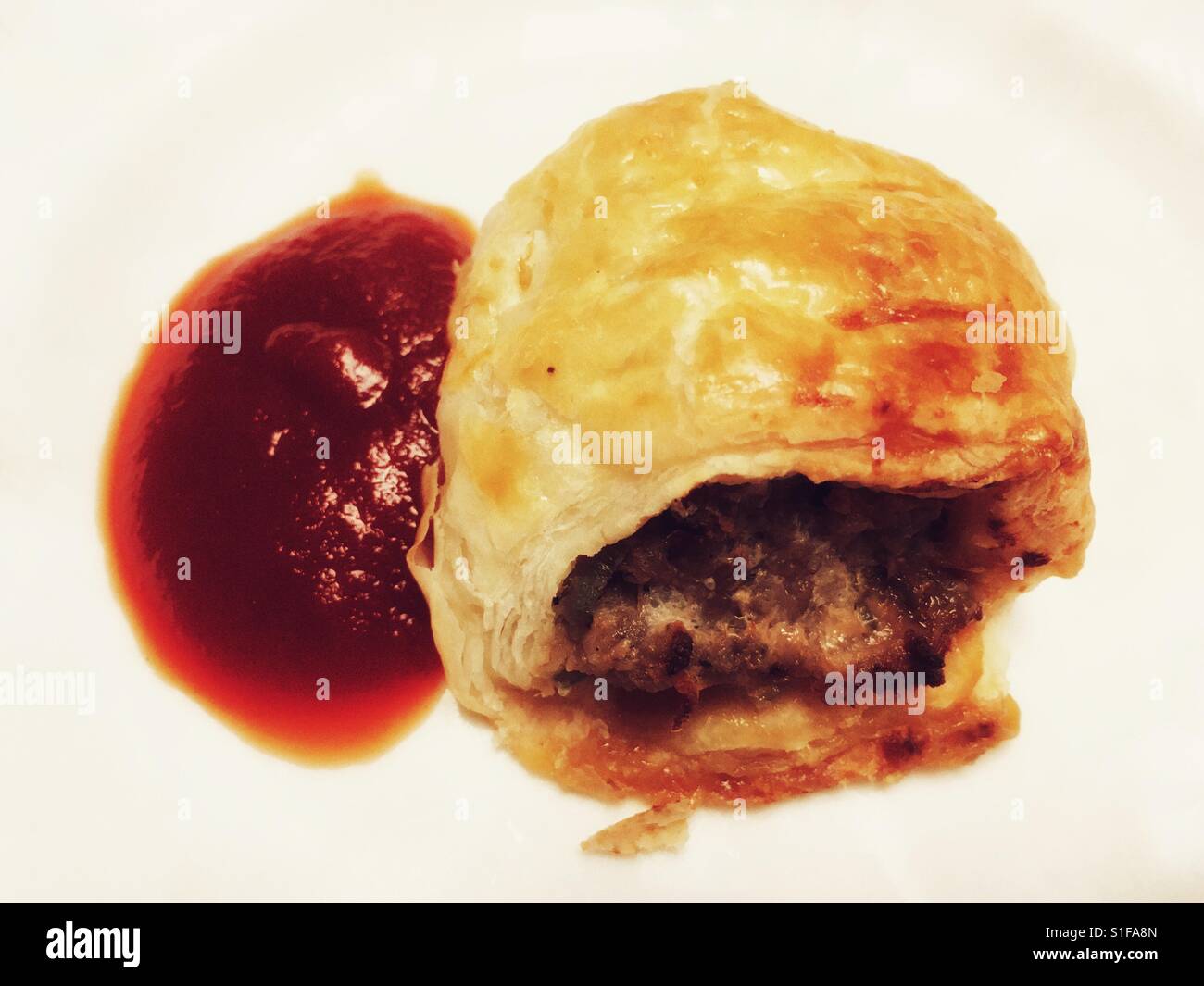 Homemade sausage roll with tomato ketchup - Smartphone Captured Stock Image
