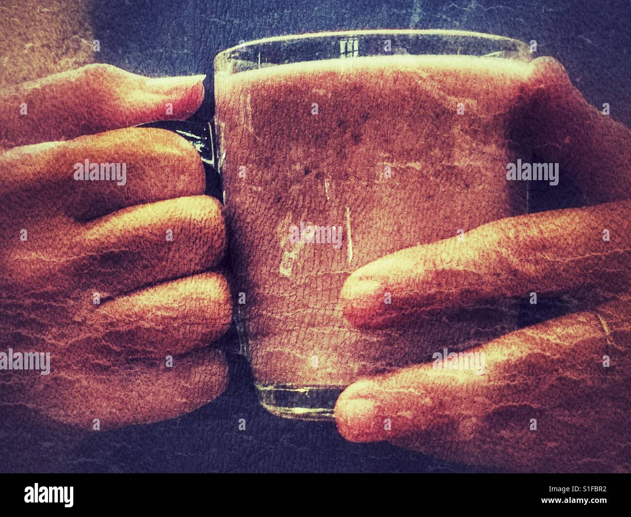 Woman holding a pink fruit smoothie, close up - Smartphone Captured Stock Image