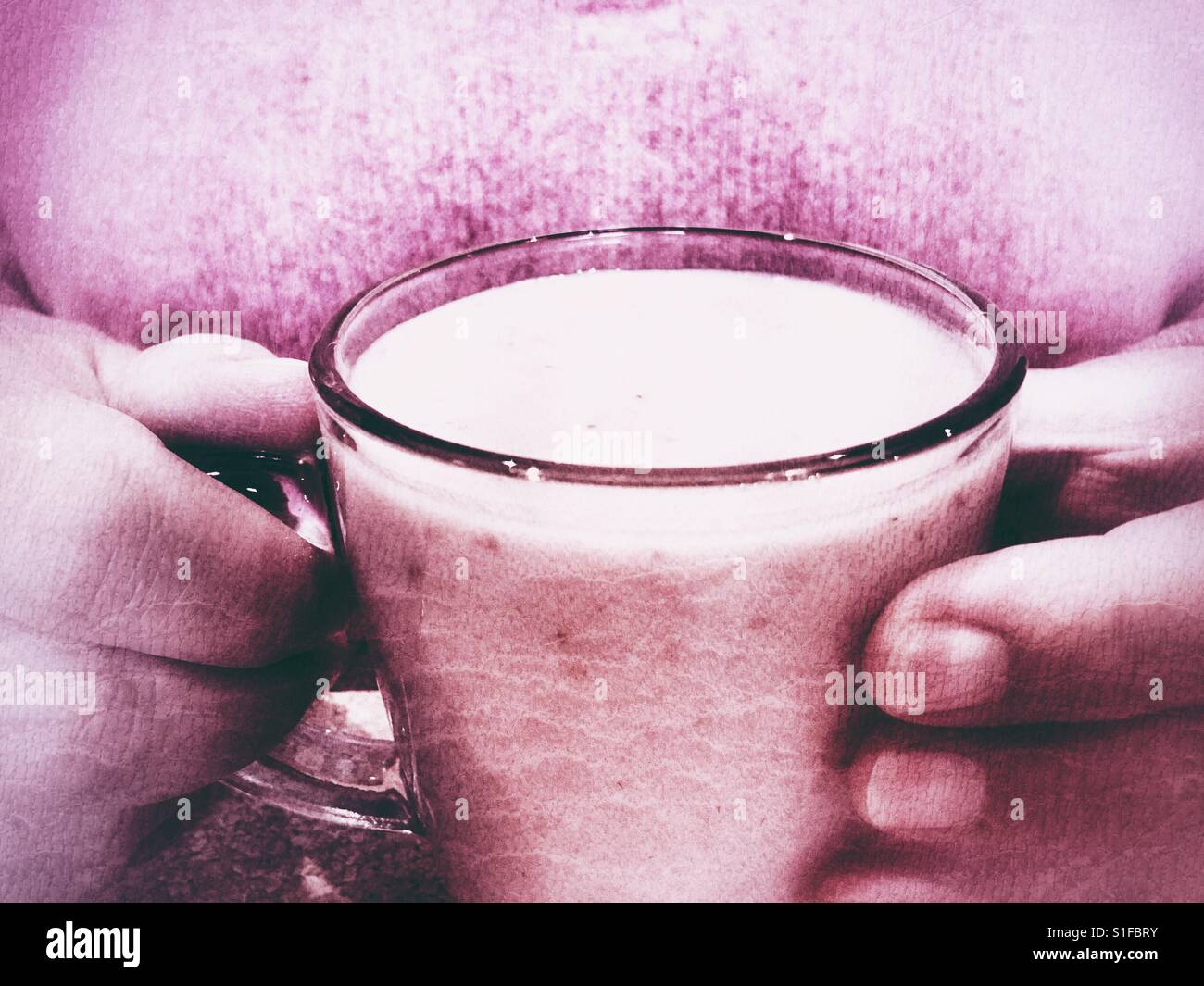 Woman in pink holding pink fresh fruit smoothie - Smartphone Captured Stock Image