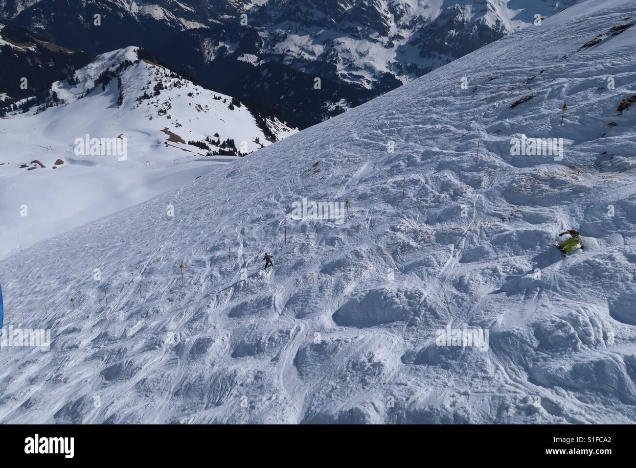 People attempting to ski and snowboard down the notorious Swiss Wall in the Porte du Soleil ski resort near Morzine on the French Swiss border. Stock Photo