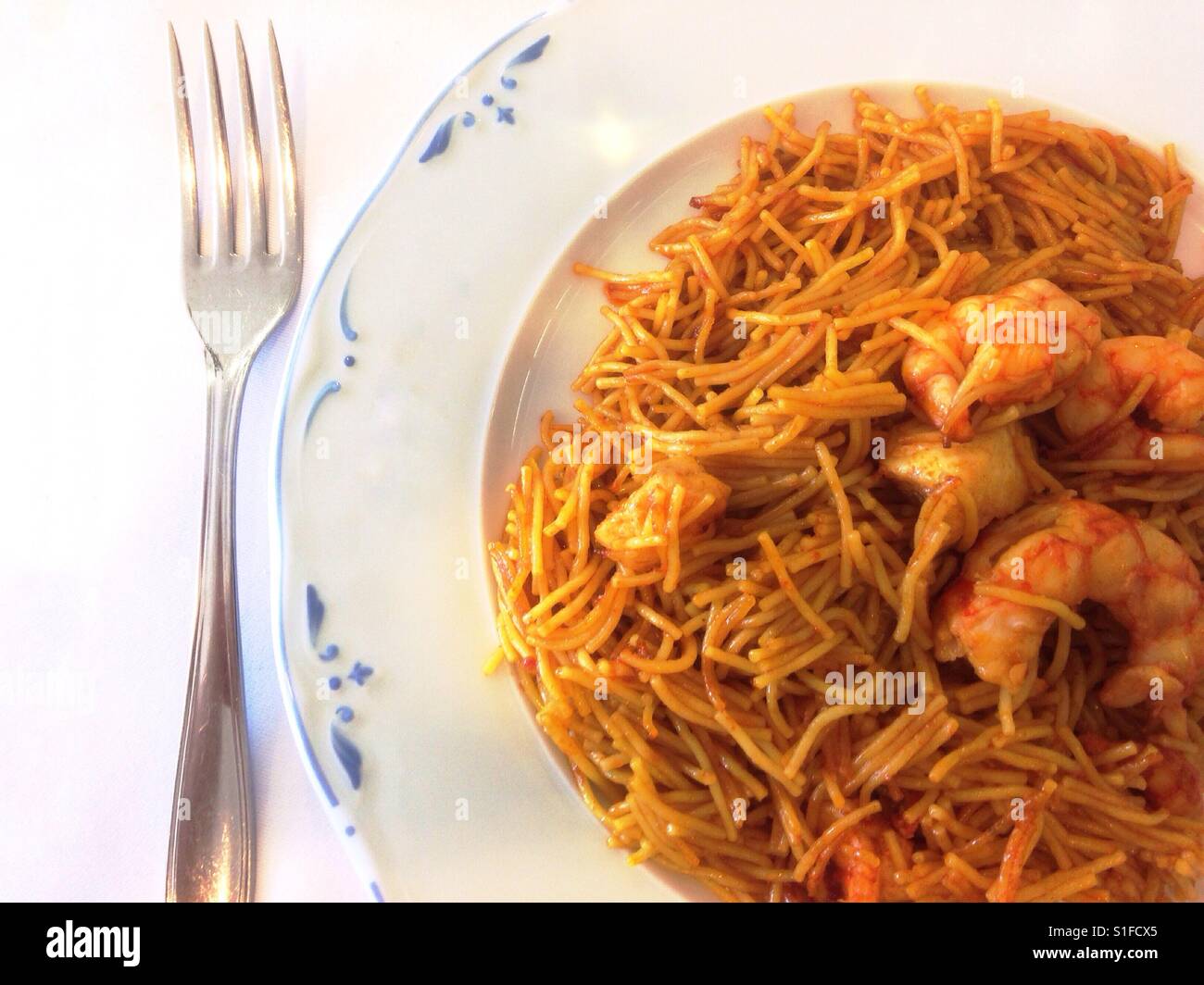 Plate of Spanish noodles and prawns. - Smartphone Captured Stock Image