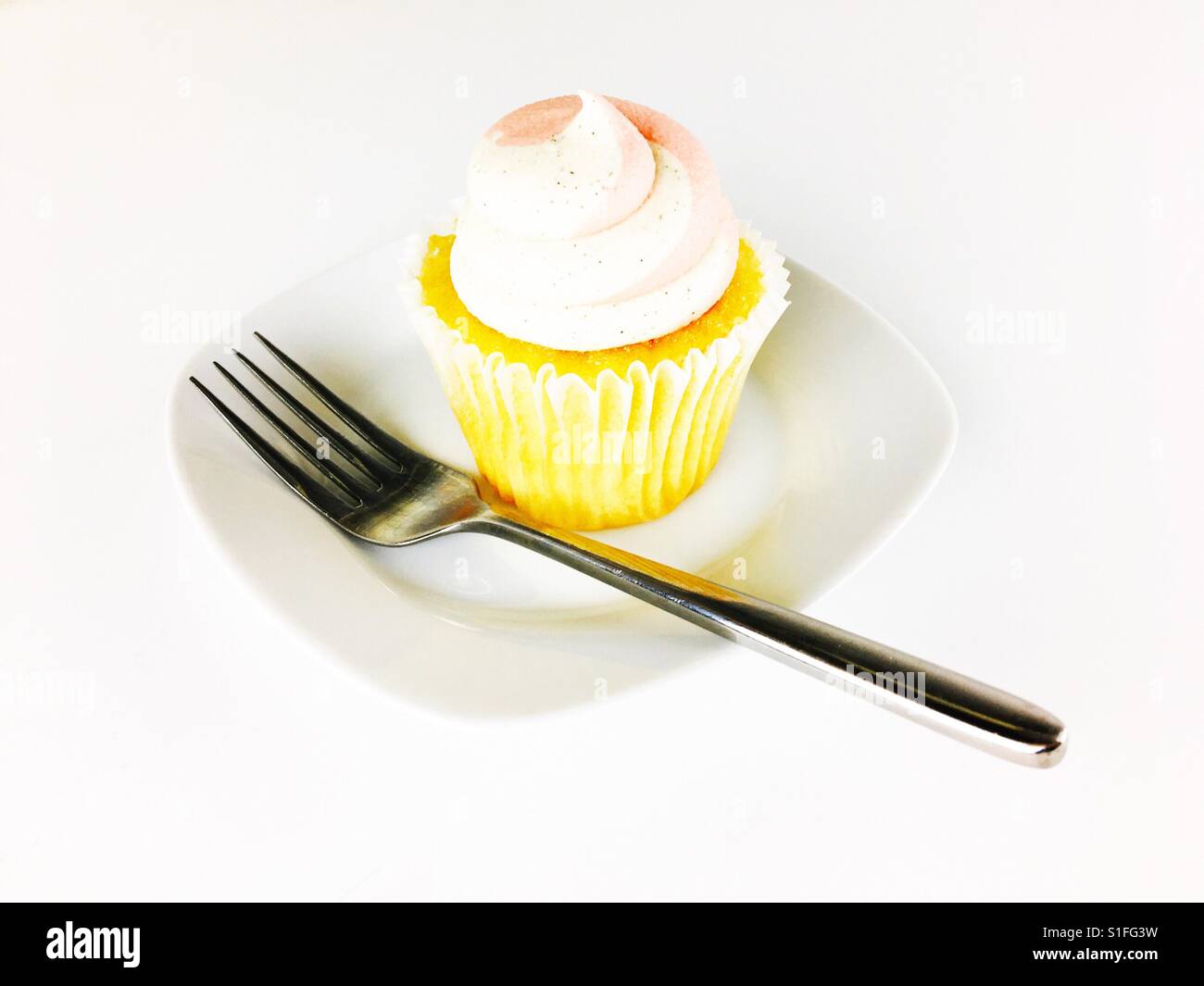 Cupcake on a plate with fork. Room for copy. - Smartphone Captured Stock Image