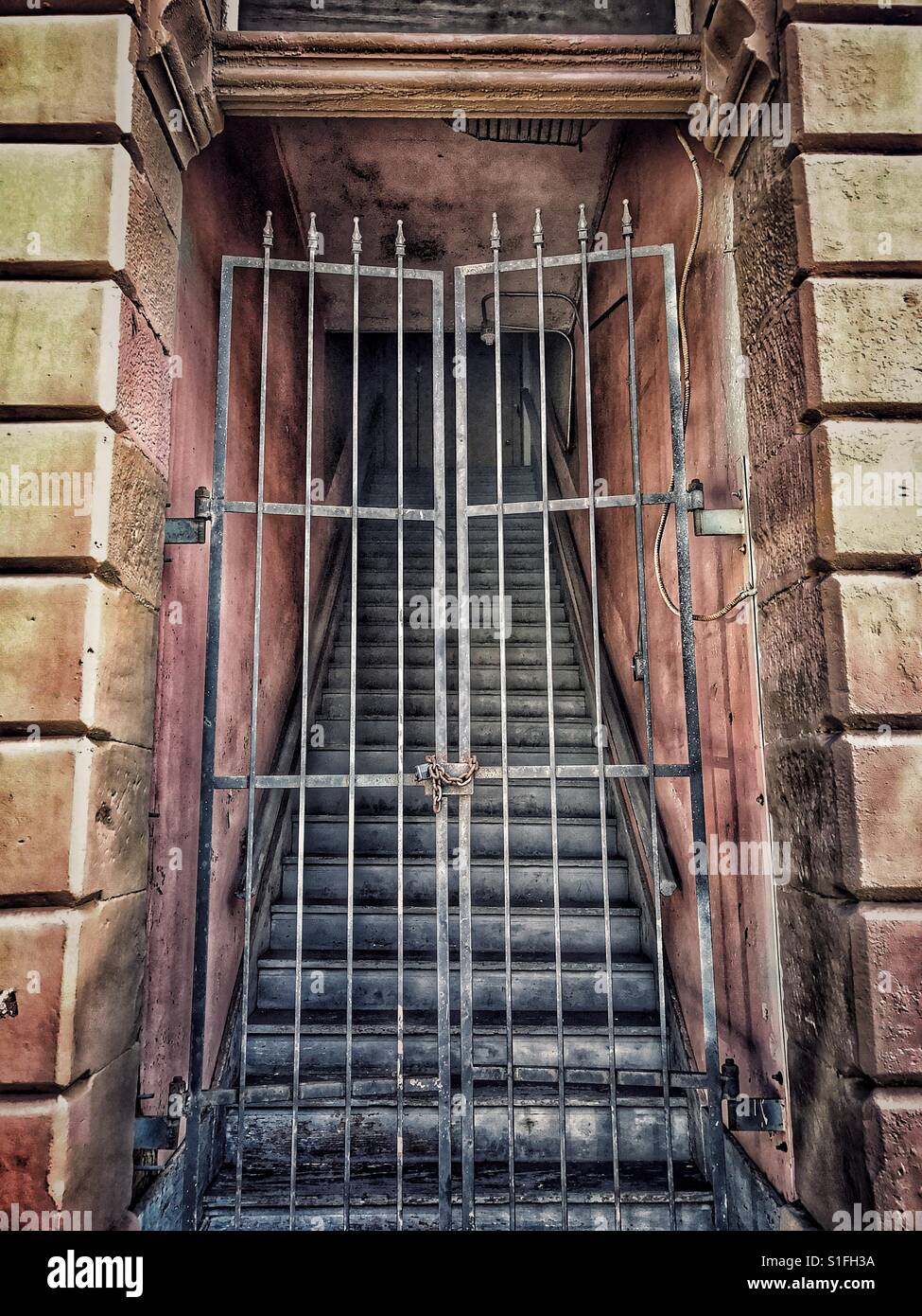 Old gated stairway Stock Photo