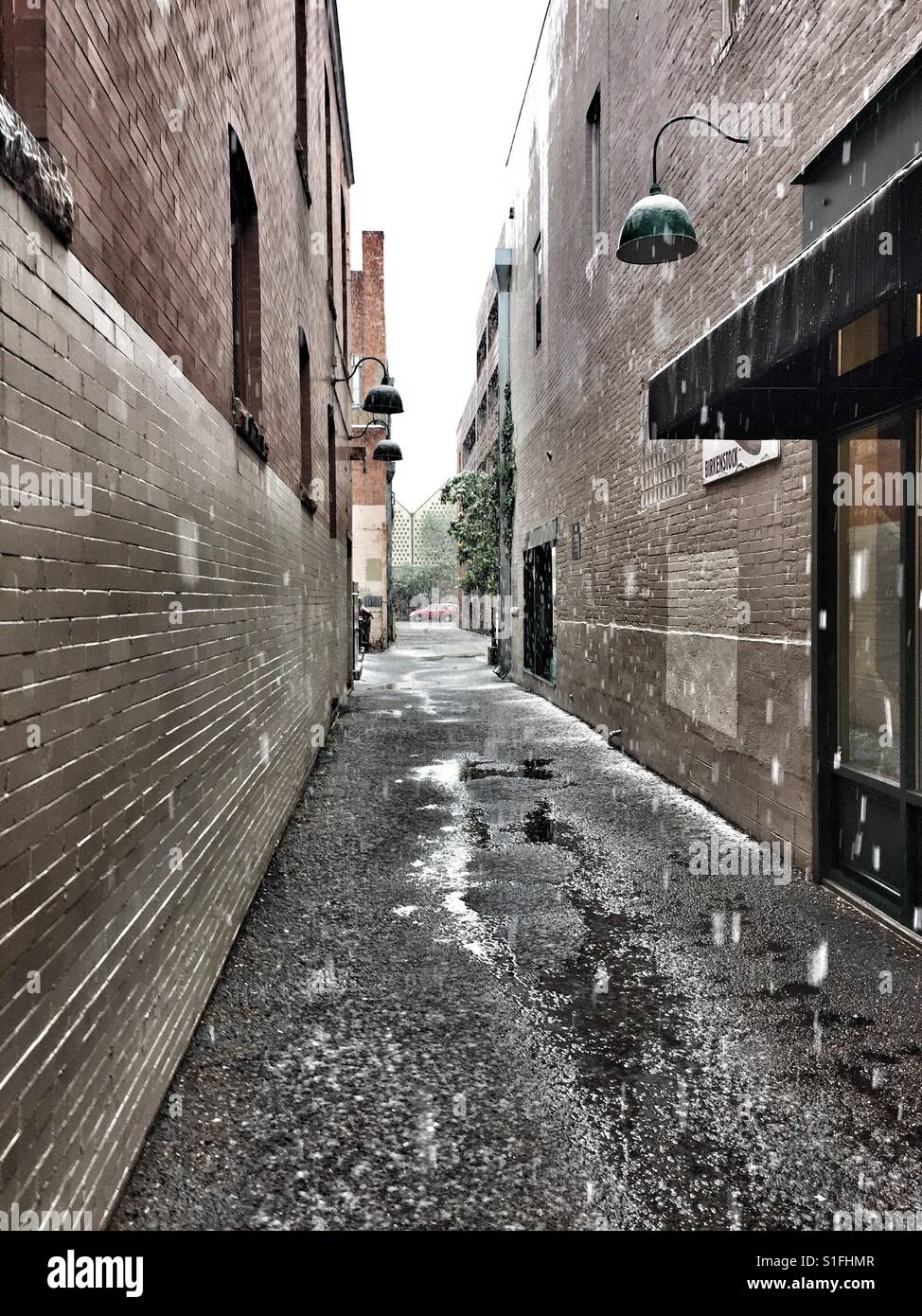 Boulder Colorado alley between two buildings during May snowstorm Stock