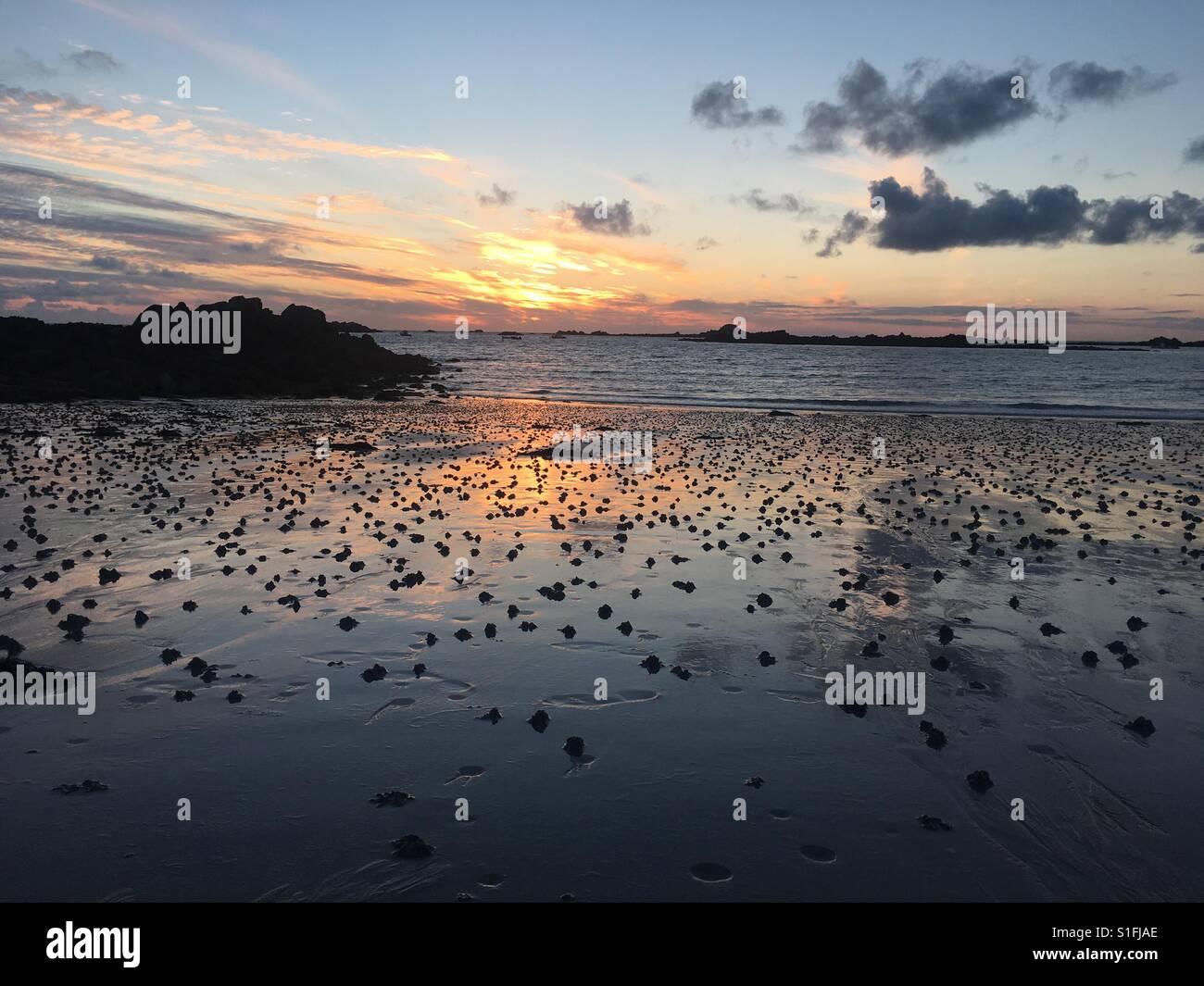 Sunset on Cobo beach on channel island of Guernsey in England - Smartphone Captured Stock Image