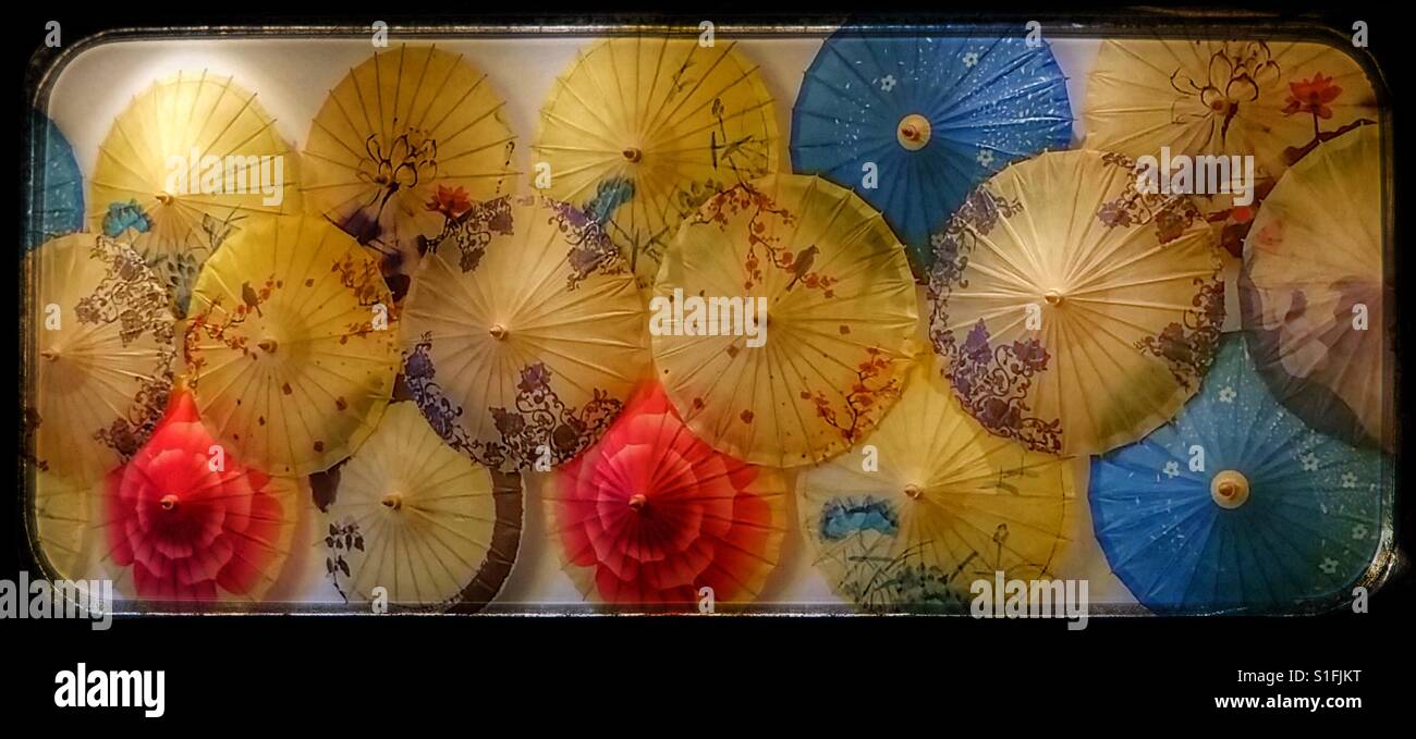 Paper sun umbrellas decorate a restaurant wall in China. Stock Photo