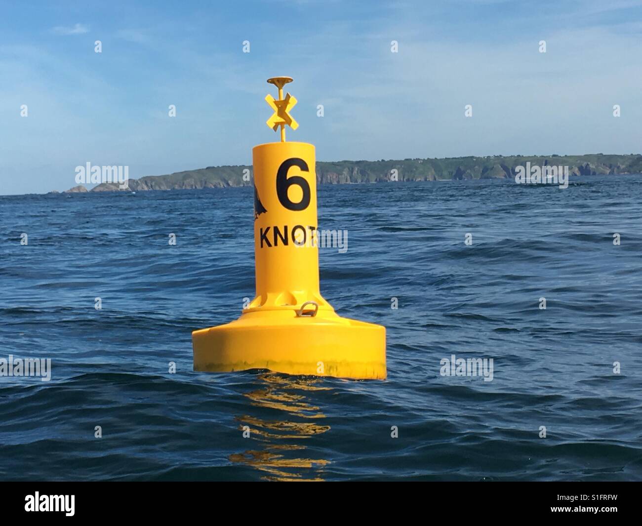 Puffin nearby 6 knot boat speed limit sign off channel island of Herm in England - Smartphone Captured Stock Image