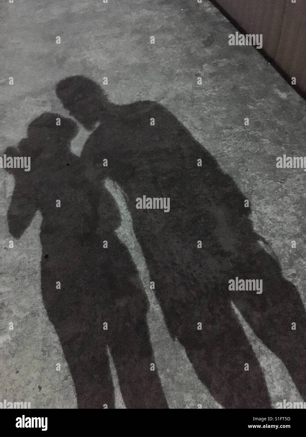 Silhouettes of a couple on the street in Singapore. Stock Photo