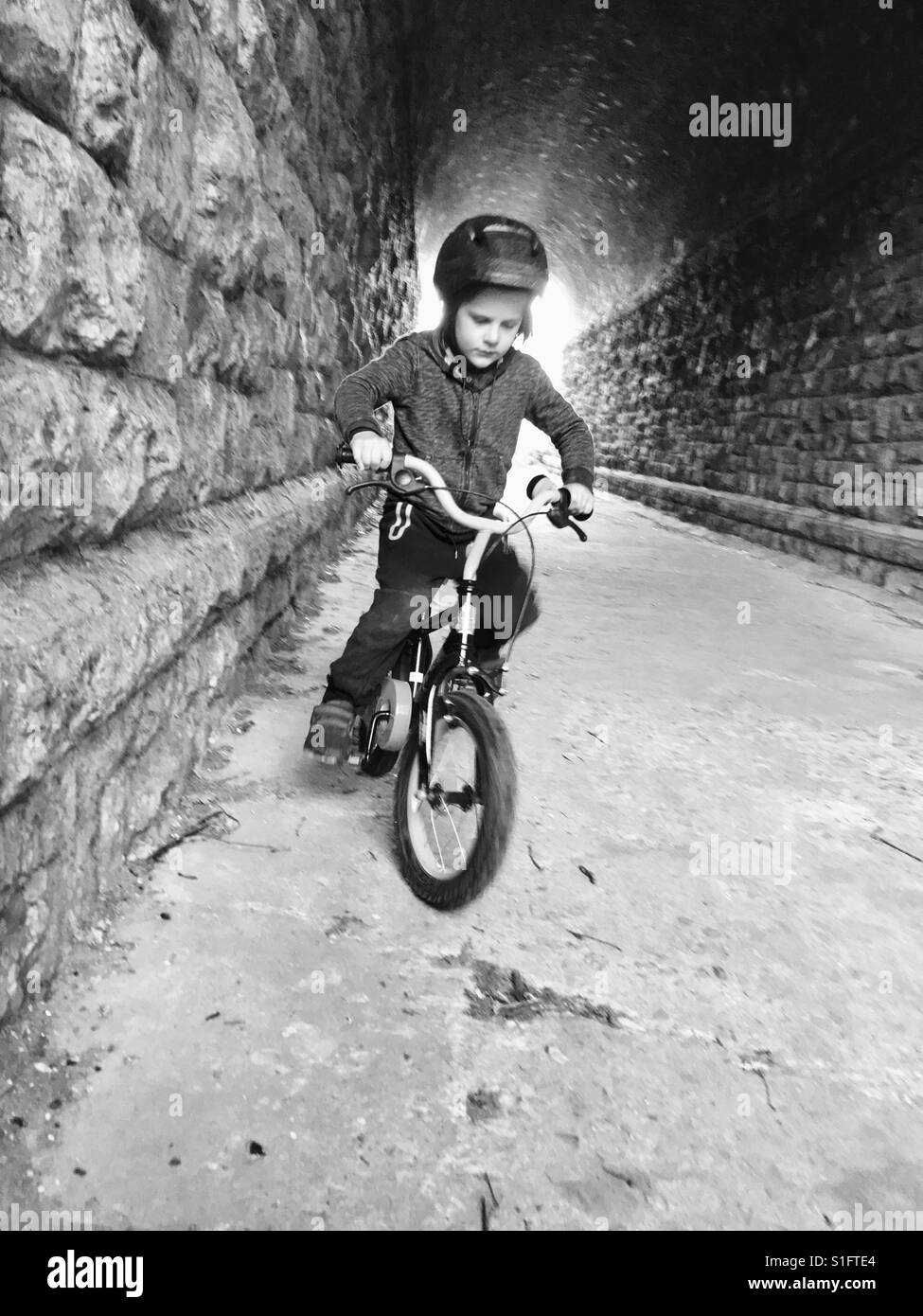Boy riding bike on two wheel Stock Photo