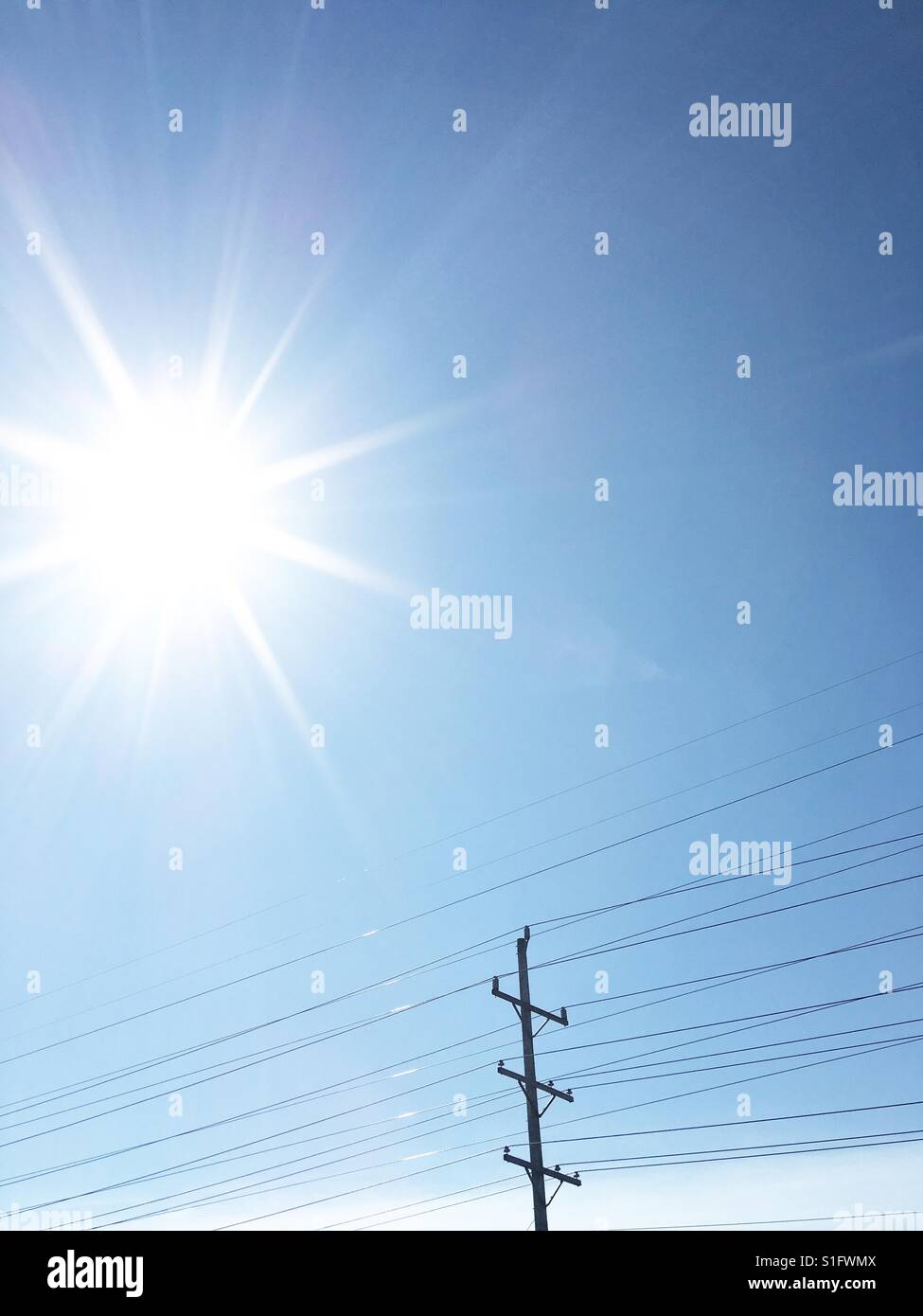 Sunburst and electrical wires Stock Photo