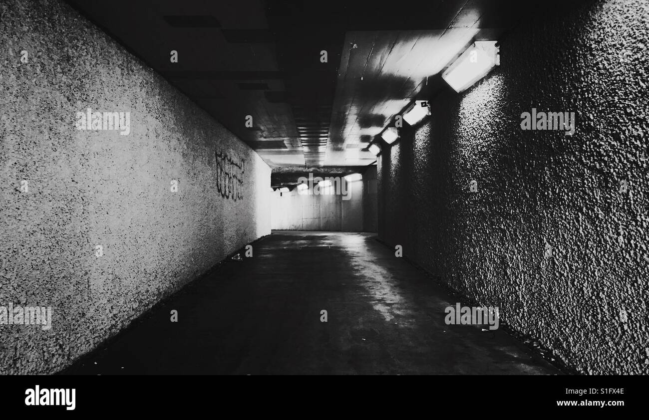 An empty cycling and pedestrian tunnel that runs beneath Granville Bridge at the Granville Loop Park in Vancouver, BC. - Smartphone Captured Stock Image