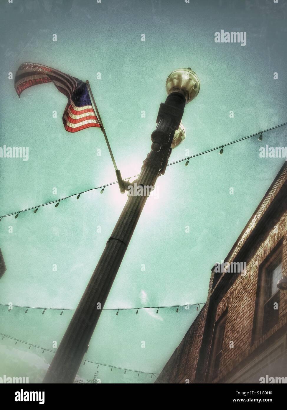 Downtown lamppost with American flag - Smartphone Captured Stock Image