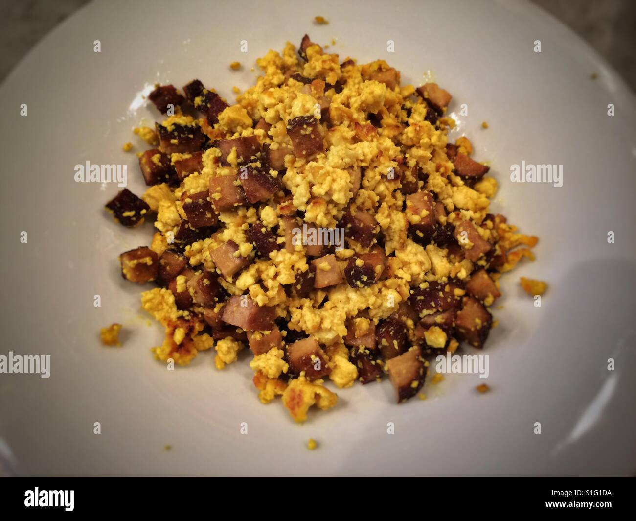 Scrambled tofu with smoked tofu cubes. - Smartphone Captured Stock Image