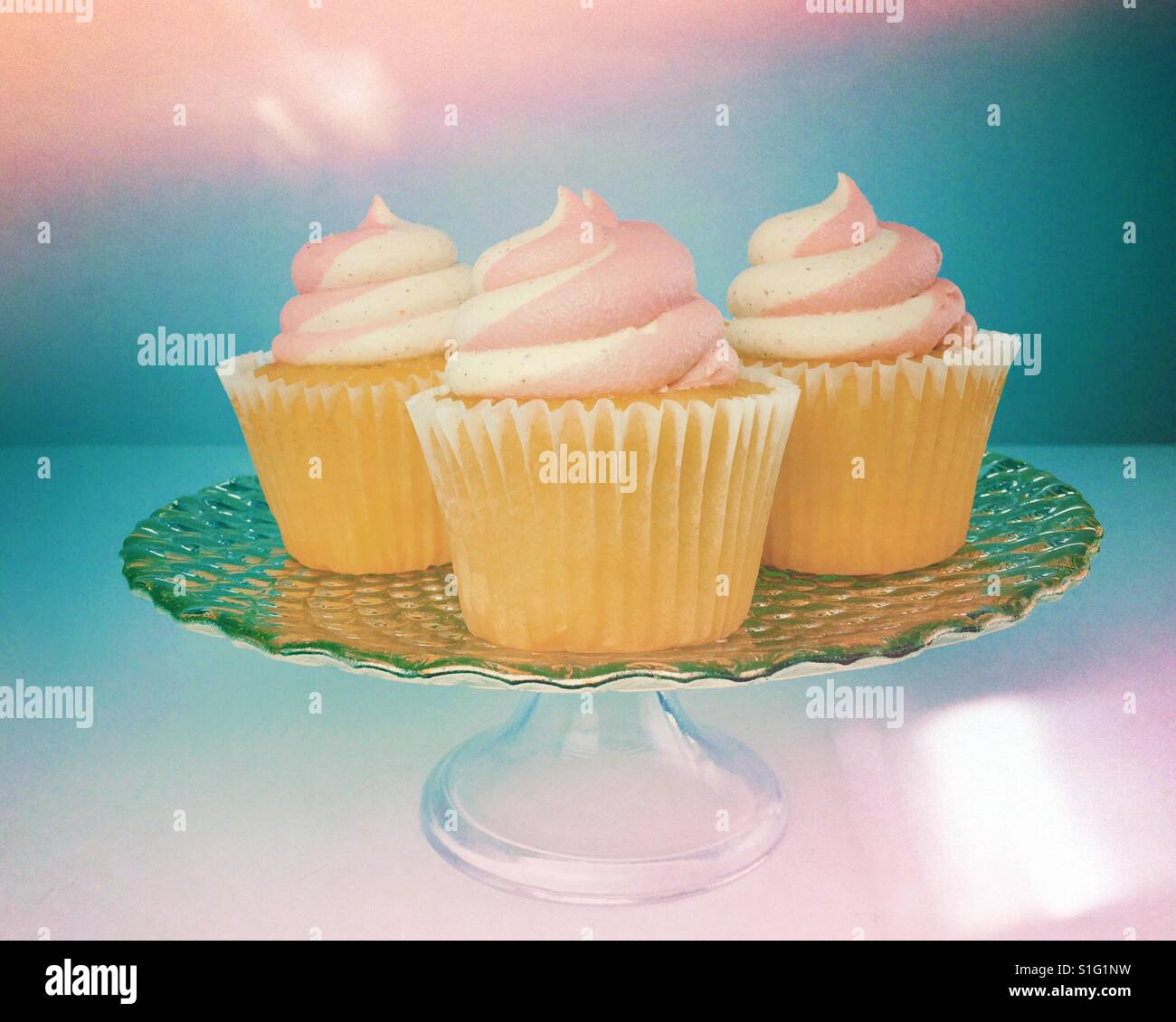 Buttercream frosted cupcakes on a serving platter. Edit with light leaks. Space for copy. - Smartphone Captured Stock Image