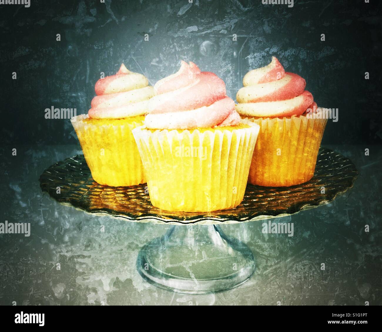 Frosted cupcakes on a glass platter. Distressed edit. - Smartphone Captured Stock Image