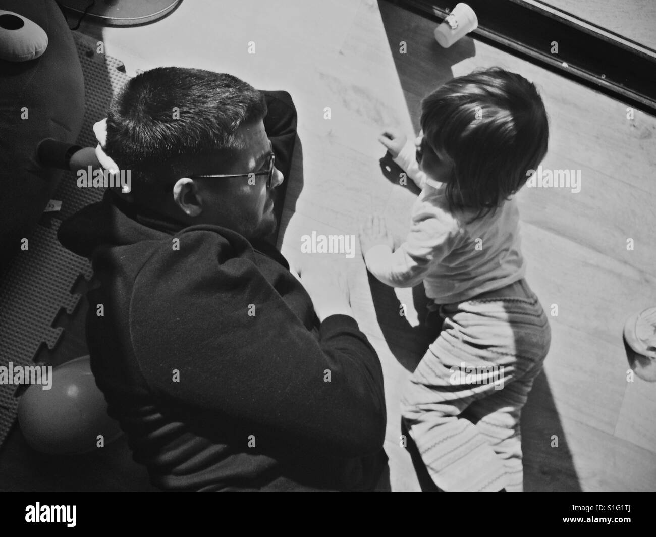 Daddy daughter toddler playtime monochrome black and white Stock Photo
