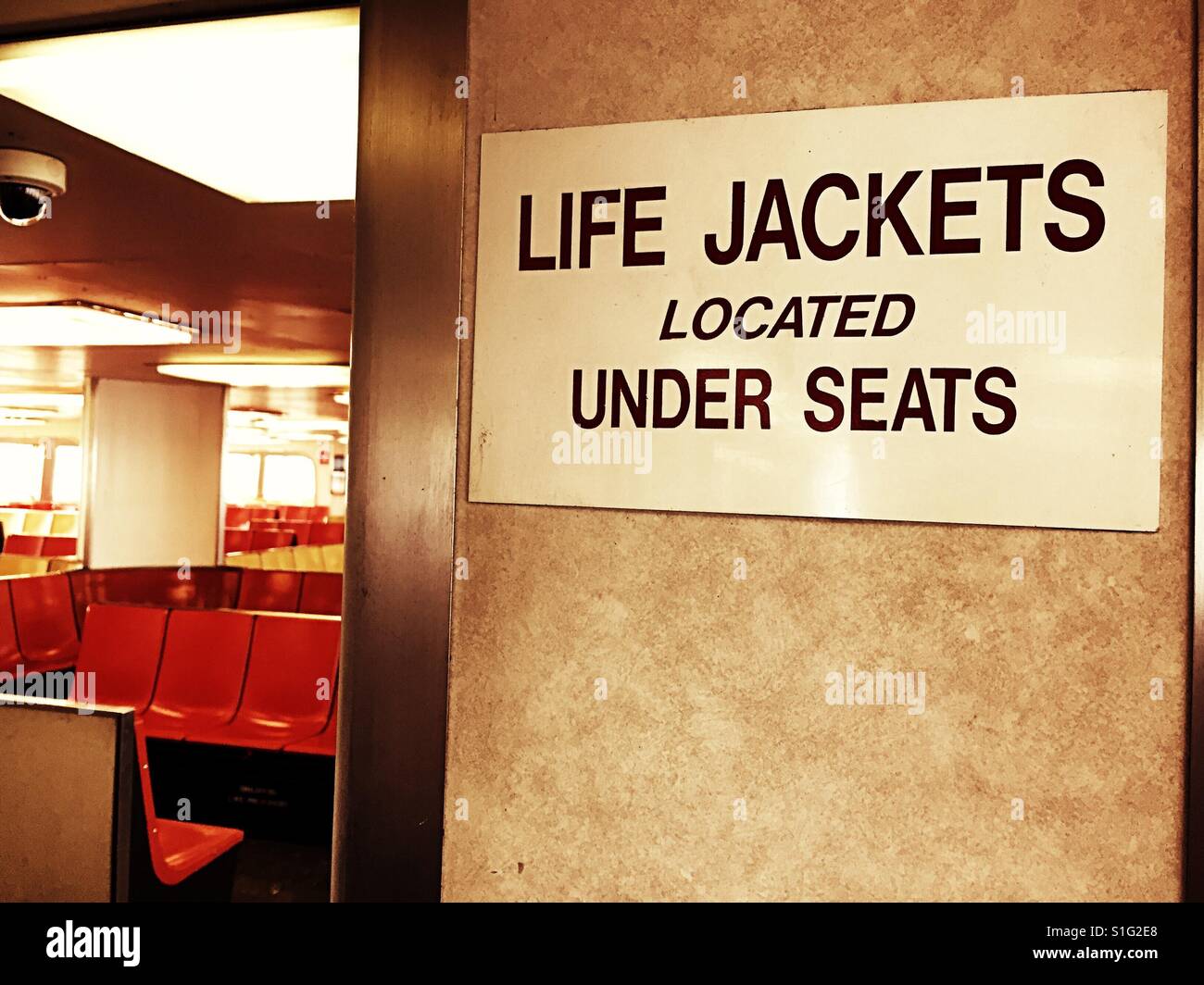 Life jacket under seats sign on the Staten Island ferry, NYC, USA - Smartphone Captured Stock Image