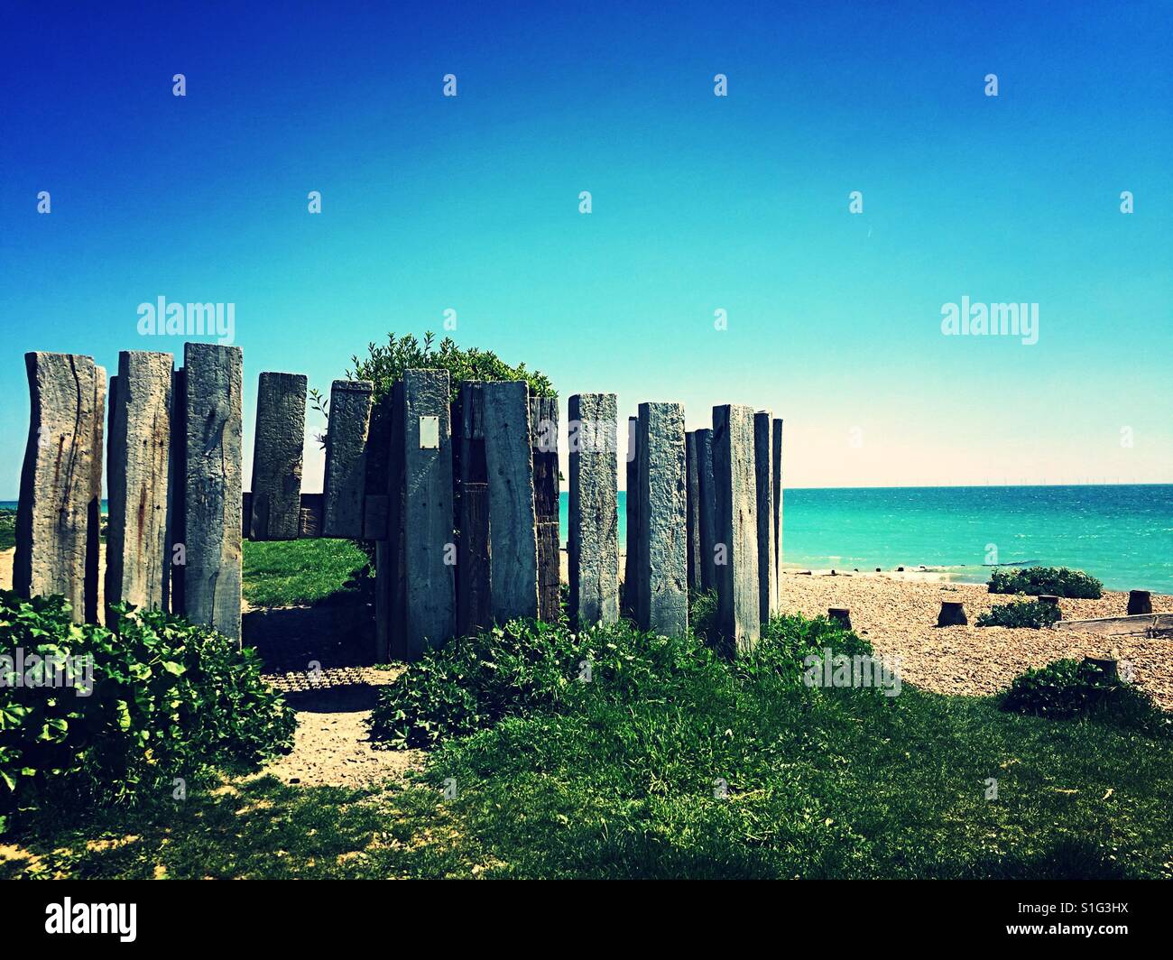 Wooden structure separating private beach area - Smartphone Captured Stock Image