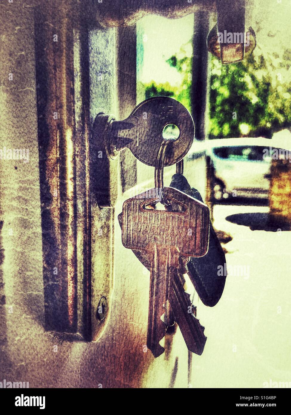 Front door keys in an open door Stock Photo Alamy