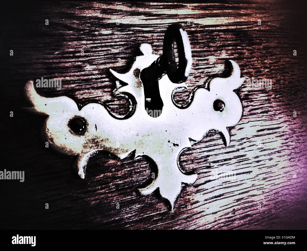 Antique lock and key in a old oak desk - Smartphone Captured Stock Image