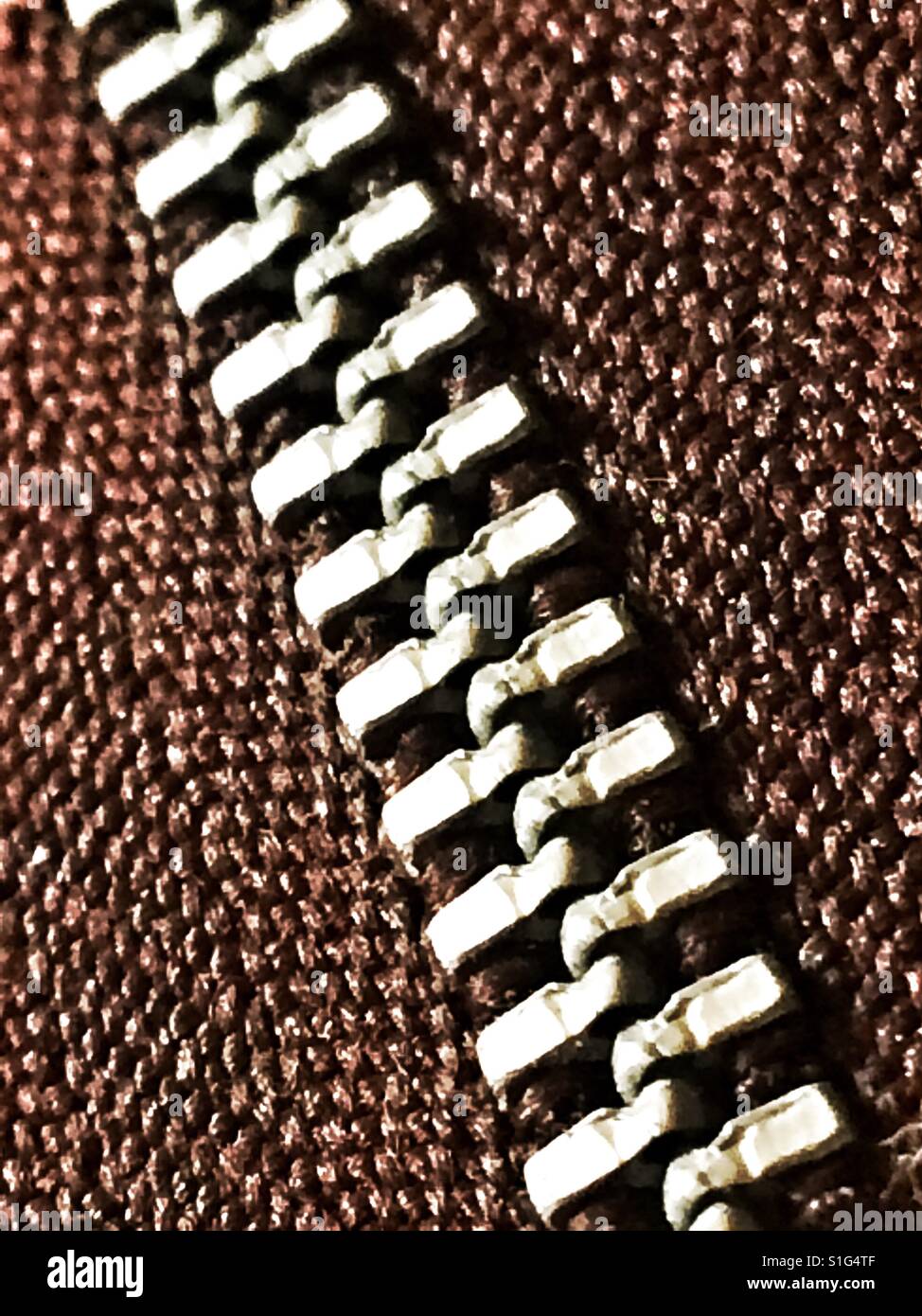 Closed zip on textured fabric Stock Photo