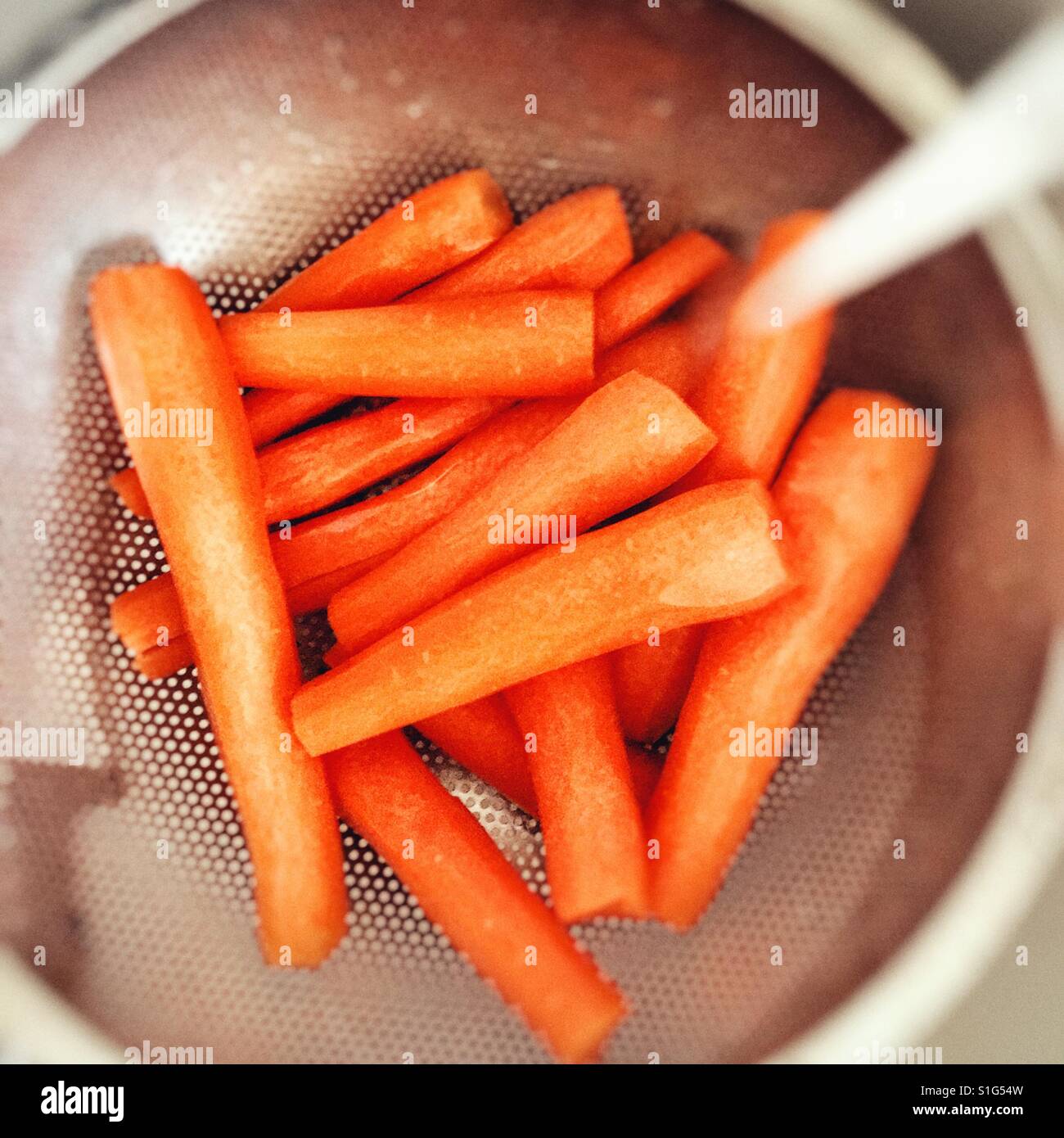 Washing peeled carrots Stock Photo Alamy