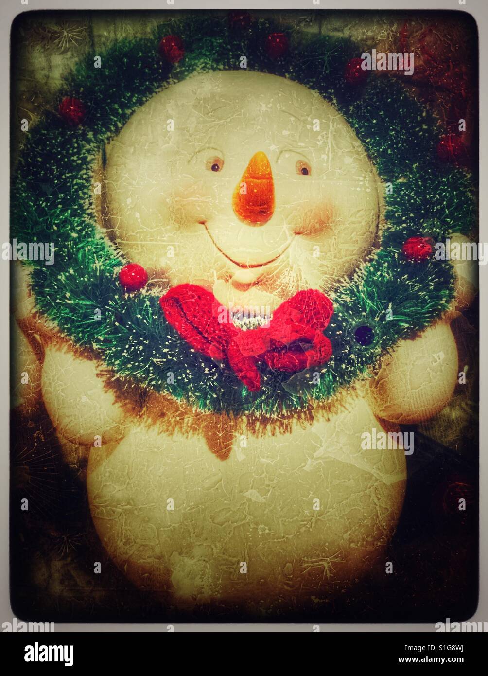 Christmas snowman with a green wreath around his neck. - Smartphone Captured Stock Image