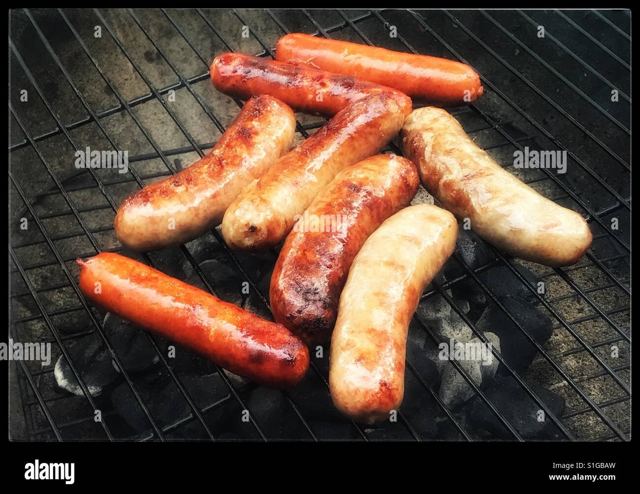 Sausages sizzling on the grill - Smartphone Captured Stock Image