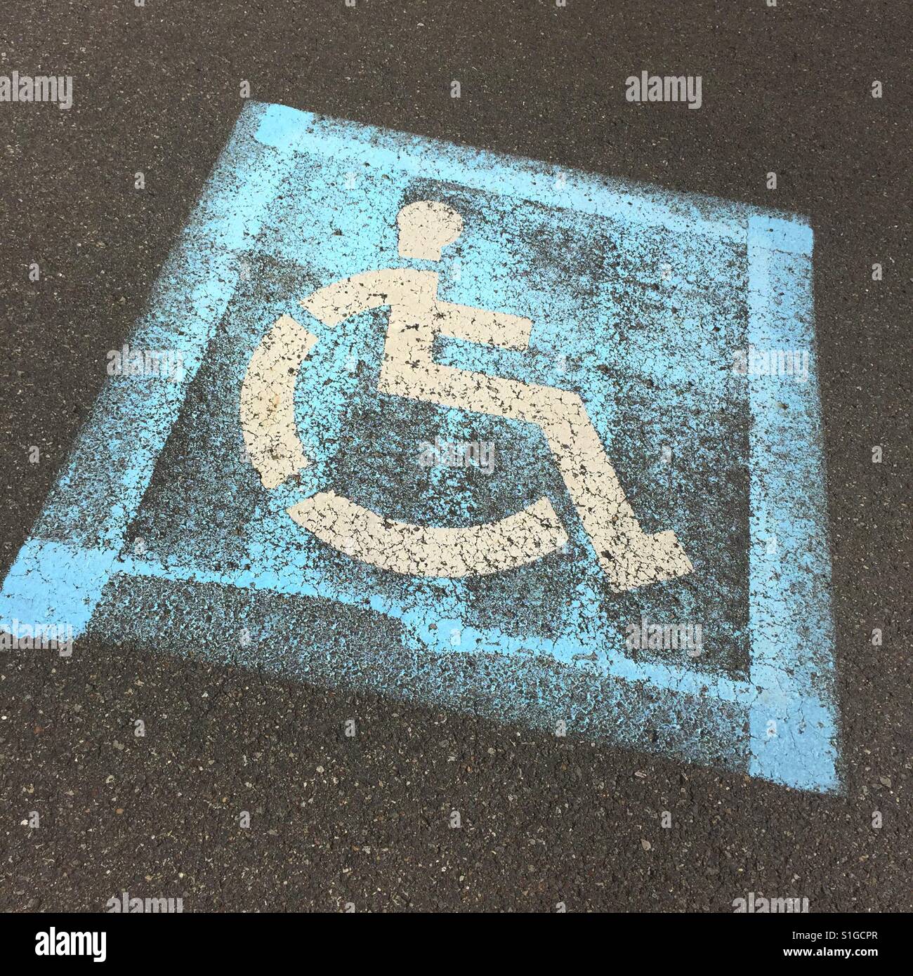 A handicap symbol painted on cement - Smartphone Captured Stock Image