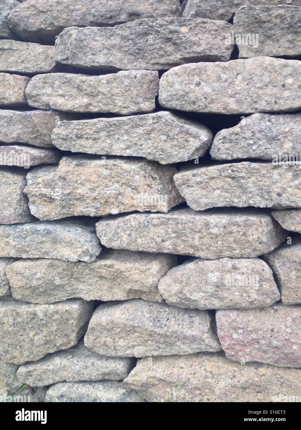 Close up of a dry stone wall (portrait orientation). Cotswolds, England. Taken by Matthew Oakes. Stock Photo