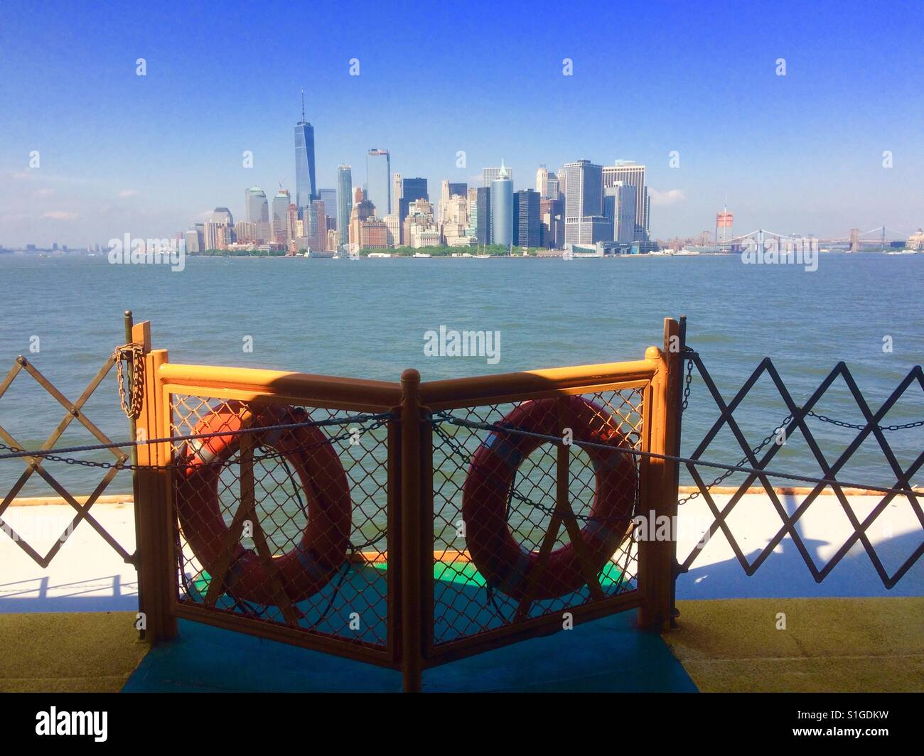 Manhatten skyline New York skyline big apple New York State from staten island ferry across the Hudson River blue sky America American iconic view - Smartphone Captured Stock Image