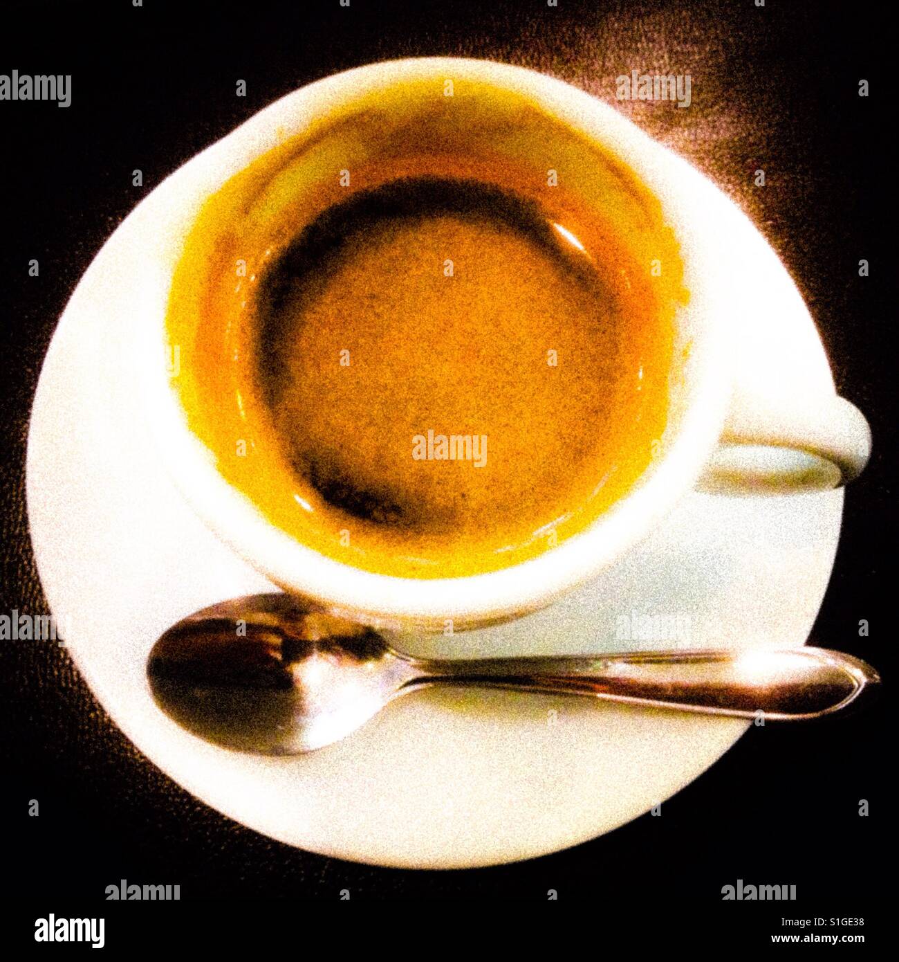 Expresso coffee in a white cup with steel coffee spoon on a dark background - Smartphone Captured Stock Image