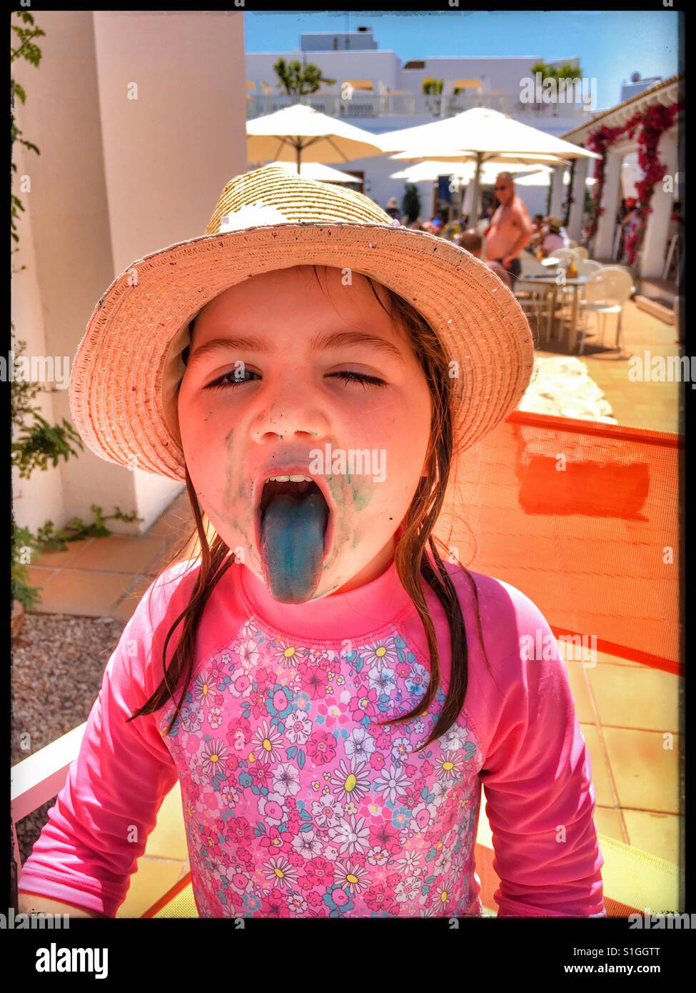 Girl with blue tongue after eating candy floss. Stock Photo