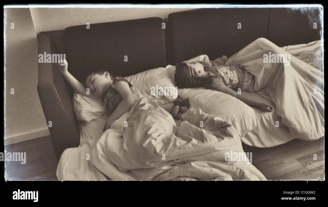 Sleeping children on sofa bed. Stock Photo