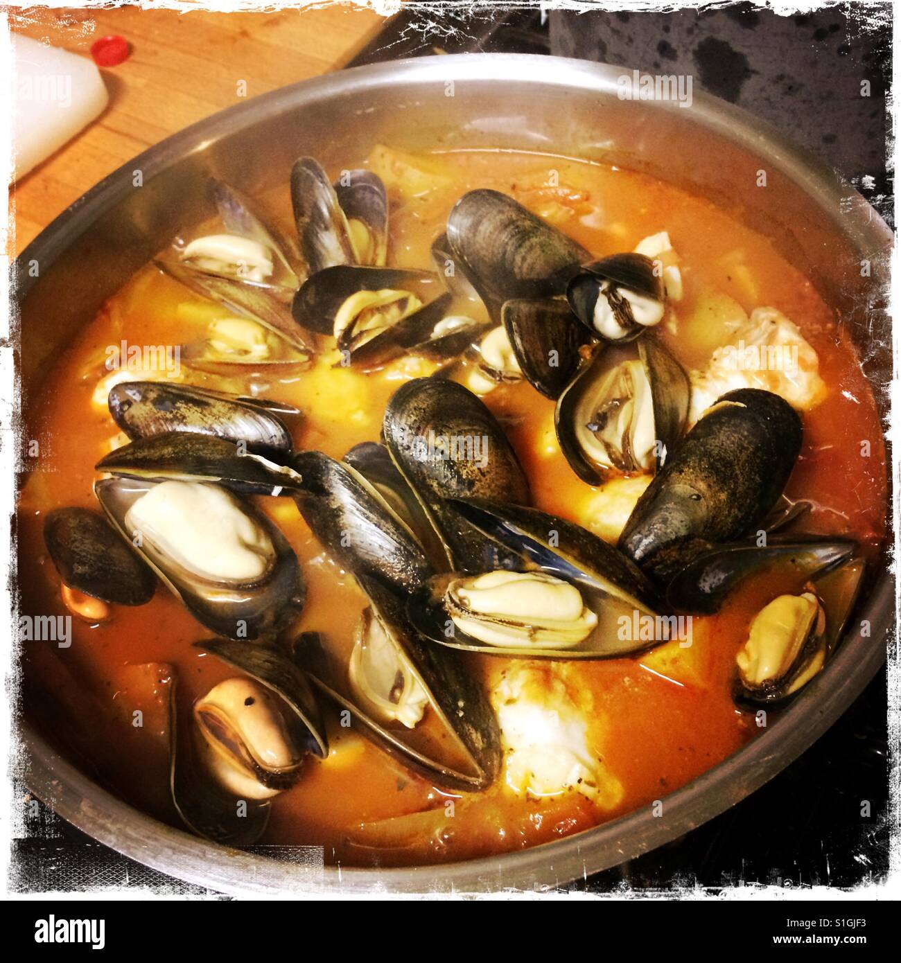 Mussels cooking in tomato sauce Stock Photo Alamy
