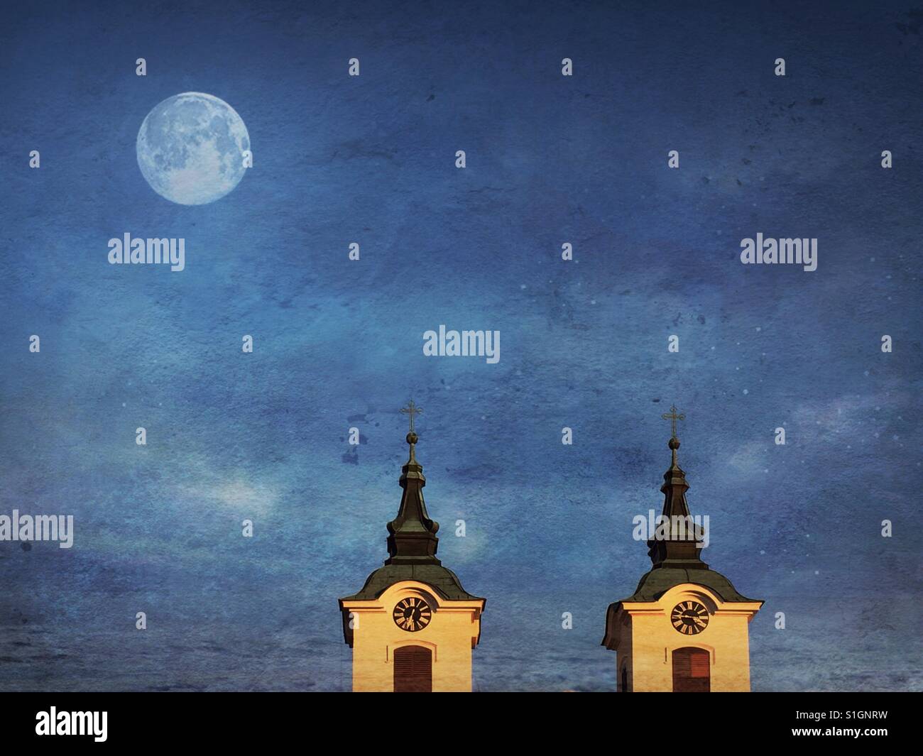 Church clock towers under a full moon - Smartphone Captured Stock Image
