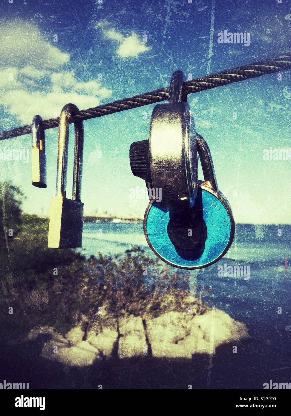 Love locks hanging on the Humber Bay bridge in Toronto, Ontario. - Smartphone Captured Stock Image