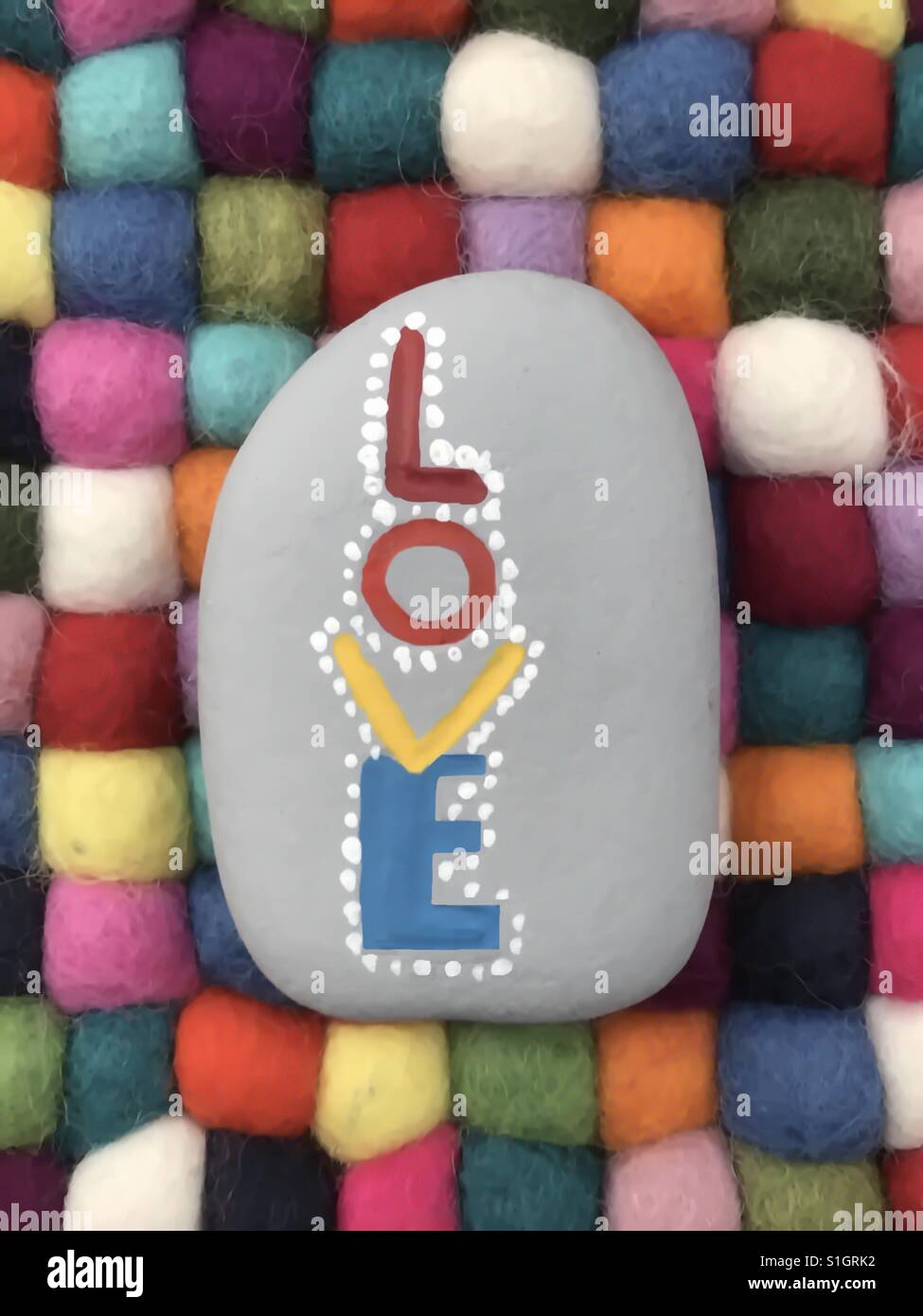 Love word carved and painted on a stone Stock Photo