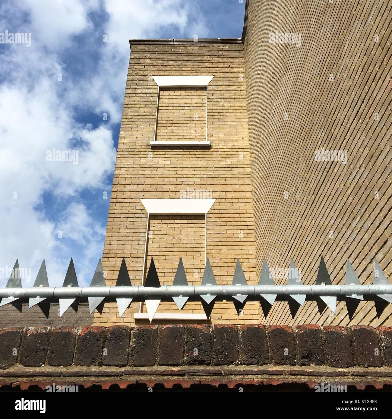 High security building with bricked-up windows - Smartphone Captured Stock Image