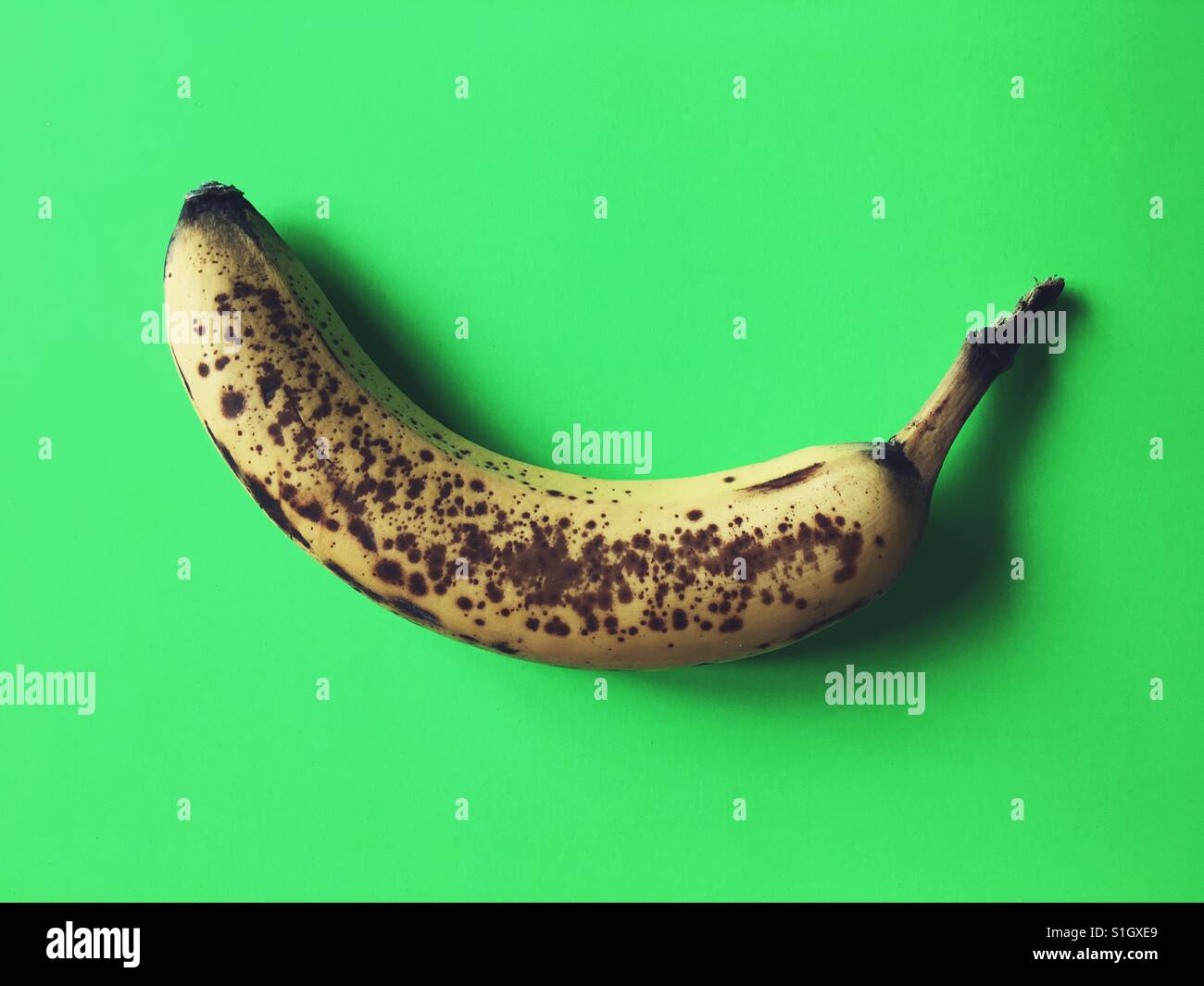 Very ripe banana on green background - Smartphone Captured Stock Image
