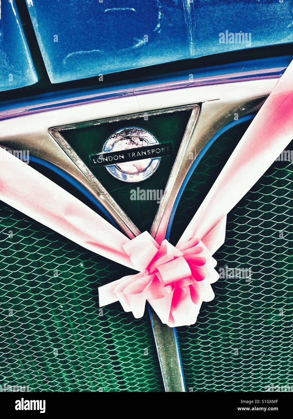London routemaster wedding bus decorated with pink ribbon - Smartphone Captured Stock Image