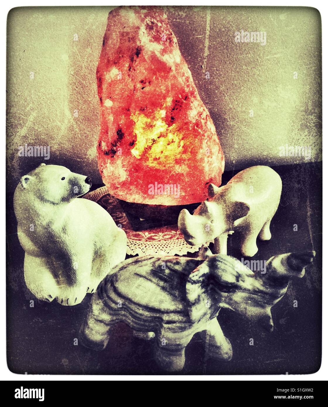 Animal statues circling a Himalayan salt lamp. - Smartphone Captured Stock Image